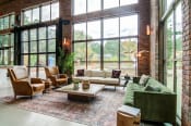 Thumbnail 9 of 16 - Affinitee at Stone Mountain Apartments photo of seating area with large windows