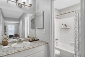 Thumbnail 14 of 16 - Affinitee at Stone Mountain Apartments photo of a bathroom with a sink and a mirror